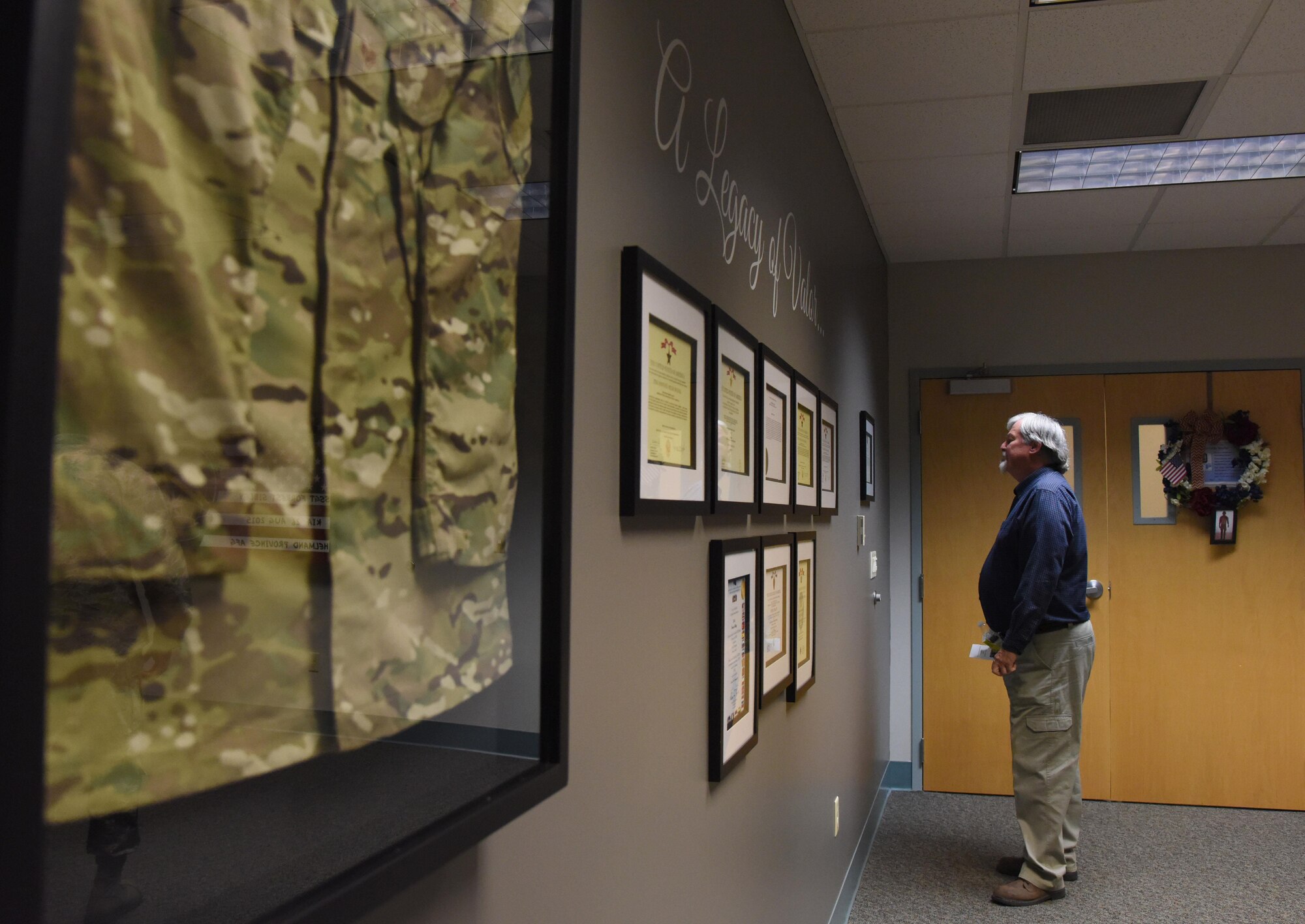 Brent Sibley admires memorabilia during a dedication ceremony to honor his son, Staff Sgt. Forrest Sibley, at Cody Hall Oct. 20, 2017, on Keesler Air Force Base, Mississippi. Sibley was killed in combat in Afghanistan on Aug. 26, 2015. Sibley, a four-time Bronze Star medal recipient, was a combat controller who received his initial technical training from the 334th Training Squadron here. (U.S. Air Force photo by Kemberly Groue)