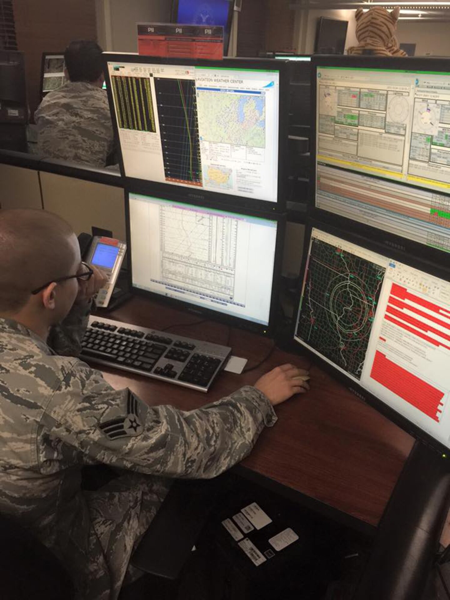 Senior Airman De Andre Davis, 12th Operational Weather Flight forecaster, works on the operations floor Oct. 23, 2017 at Scott Air Force Base, Ill. The 12th OWF was recently gained by the 403rd Wing as a geographically separated unit. (U.S. Air Force photo)