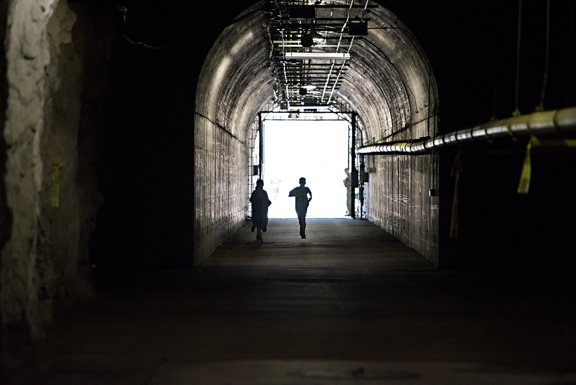 Runners enter the south portal of Cheyenne Mountain Air Force Station, Colorado, during the Zombie Tunnel 5k Fun Run, Oct. 20, 2017. The run gave Front Range military members and their families an opportunity to have an inside look at Cheyenne Mountain AFS. (U.S. Air Force photo by Steve Kotecki)