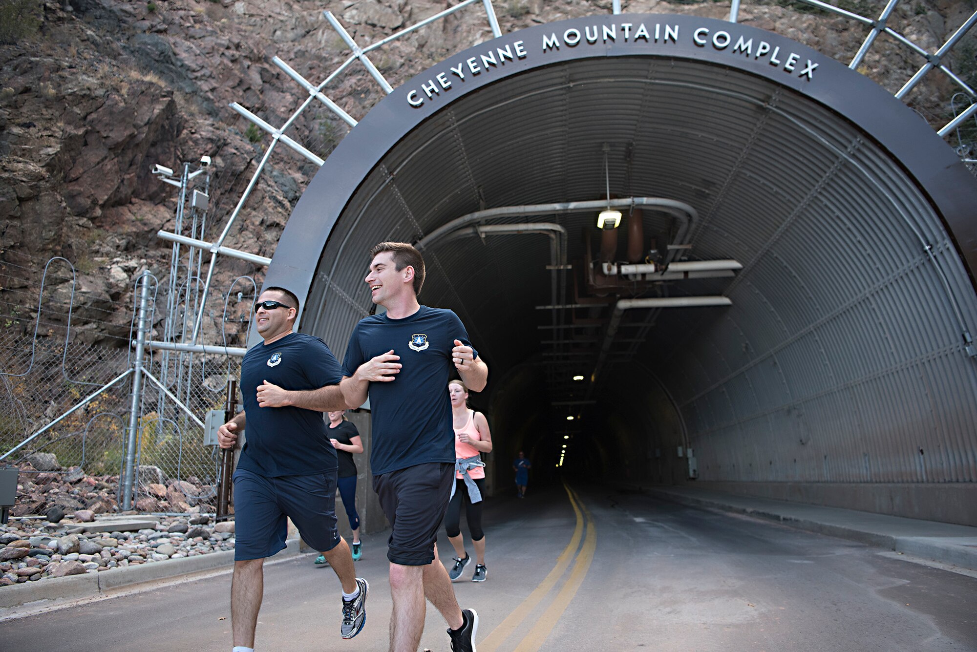 Runners exit the north portal of Cheyenne Mountain Air Force Station, Colorado, during the Zombie Tunnel 5k Fun Run, Oct. 20, 2017. The run gave participants the opportunity to run the full length of the Cheyenne Mountain AFS tunnel. (U.S. Air Force photo by Steve Kotecki)