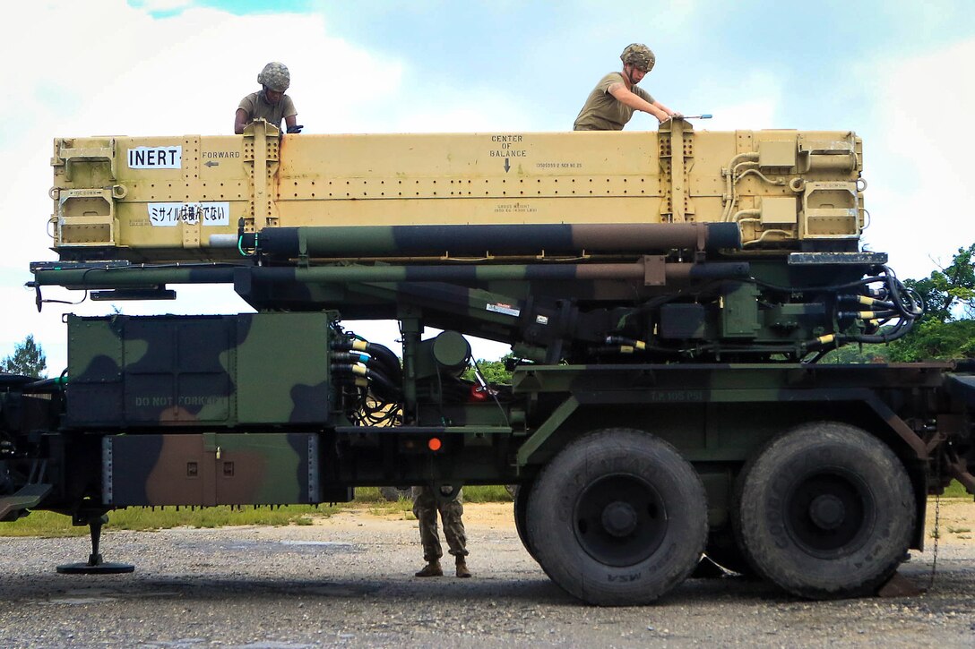 Soldiers loosen up bolts on a Patriot missile system equipment during a table gunnery training exercise.