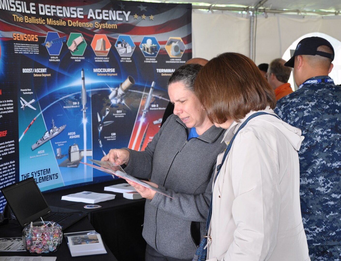 IMAGE: DAHLGREN, Va. (Oct. 16, 2017) – Military and civilian personnel learn more about the Aegis Ballistic Missile Defense (BMD) command in the exhibit tent while celebrating the centennial of the Navy base at Dahlgren. Aegis BMD is both the Navy element of the Missile Defense Agency, as well as a field activity of the Naval Sea Systems Command. It builds upon and extends capabilities inherent in the Aegis Weapon System, Standard Missile, and Navy command and control systems. Aegis BMD ships provide the Combatant Commanders with significant flexibility to meet changing operational demands.
