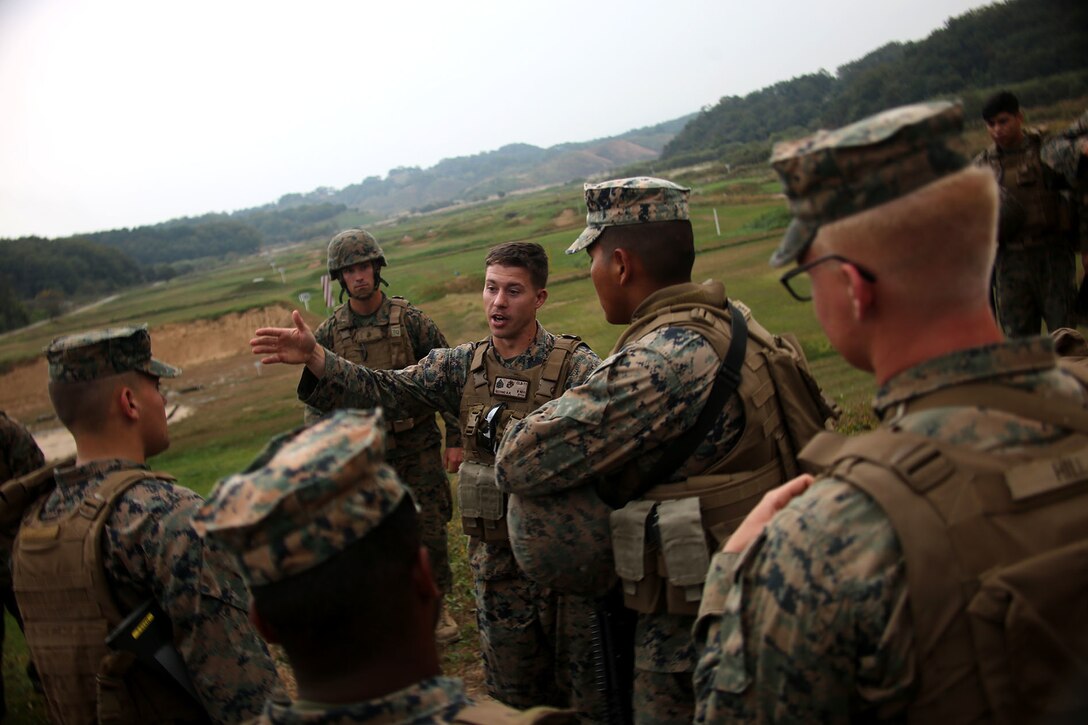 A Marine briefs his team on range safety.