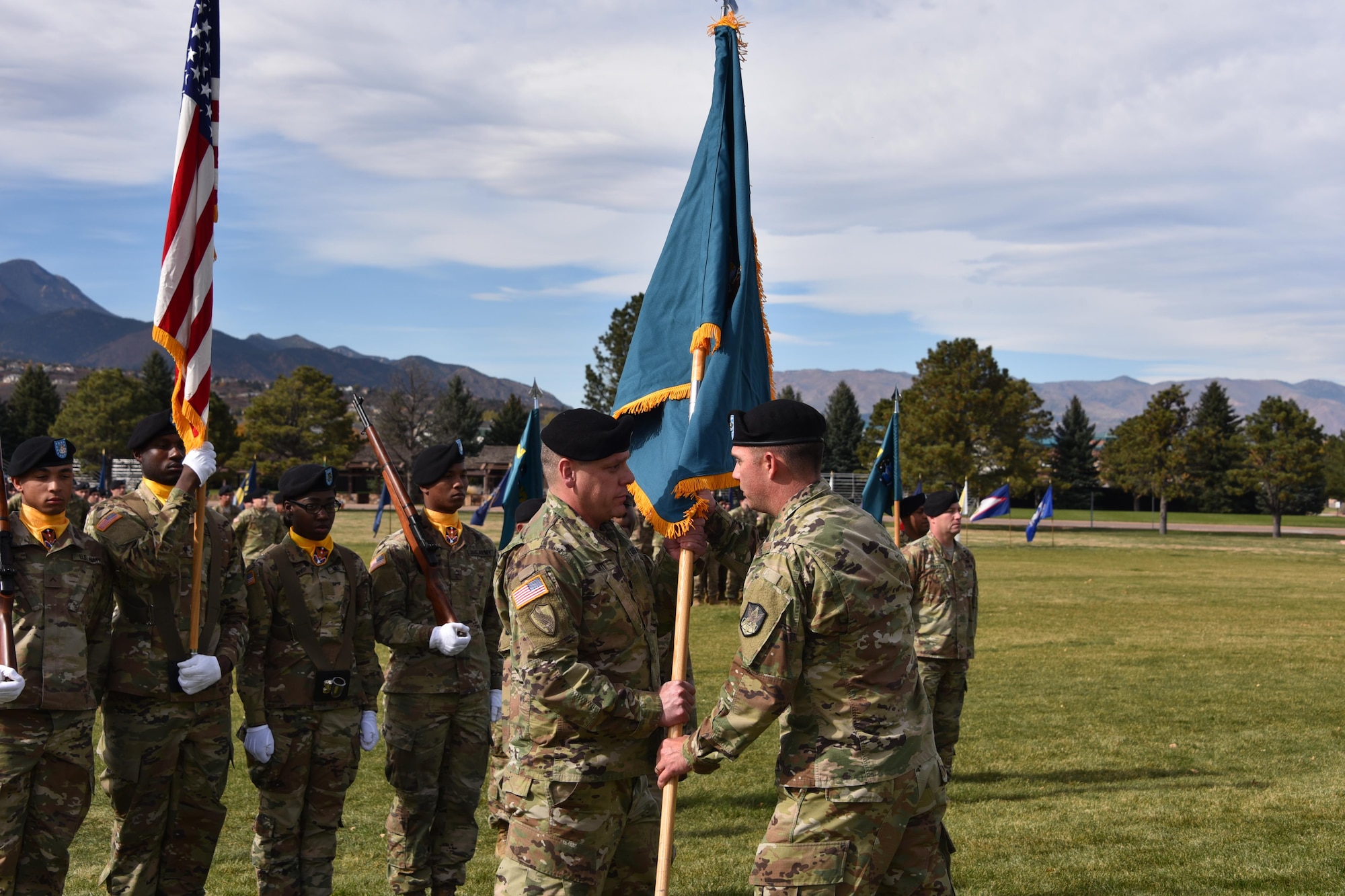 Col. Richard Zellmann, 1st Space Brigade commander, passes the 2nd Space Battalion colors to Lt. Col. Erikk Hurtt during an activation ceremony Oct. 16 at Fort Carson, Colorado, entrusting him to care for and lead the unit as its first battalion commander. (U.S. Army photo by Dottie White)