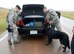 Senior Airman Chris Inman, left, and Staff Sgt. James Stiegler, both with the 72nd Security Forces Squadron, and Military Working Dog Kali inspect the contents of a vehicle which was used in a gate-runner scenario for a War Wagon exercise Oct. 4.