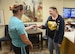 Christina Austin, with 72nd Air Base Wing Force Support Squadron, checks Samantha Johnson’s, 72nd Medical Operations Squadron, I.D. at the Child Development Center West during a War Wagon exercise Oct. 4. Force protection conditions were elevated to FPCON Charlie during the exercise, denoting that local terrorist activity is imminent and would warrant the base, as well as facilities within, to issue 100 percent ID checks.
