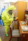 Senior Airman Kristina Song, with the 72nd Aerospace Medicine Squadron’s Bioenvironmental Flight, monitors air quality in a simulated contaminated area during the Oct. 5 CBRNE exercise. Wearing a Level A Hazmat fully-encapsulated suit, Airman Song is able to communicate with her team, monitor the air, identify chemicals, take photos of the scene and take samples of liquids or powder if necessary