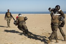 Gunnery Sgt. Jemille Issaac (left) a Marine Corps Martial Arts Program instructor-trainer, evaluates his students’ hand-to-hand techniques during a MCMAP instructor certification course  at Fort Story, in Virginia Beach, Va., Oct 19. MCMAP instructors are required to pass a three-week course in order to earn a tan tab on his or her belts before they are certified to teach Marines in the program. (Official Marine Corps photo by Chris Jones/Released)