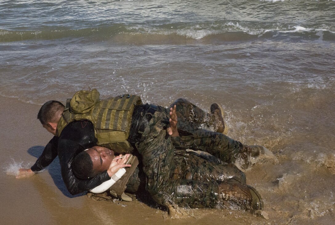 Capt. Joe A. Saenz, (top) a Marine Corps Martial Arts Program instructor-trainer, tests Sgt. Nicholas Diego’s ground-fighting techniques during a MCMAP Instructor Course training session at Fort Story in Virginia Beach, Va., Oct. 19. The students were required to face off against their instructor-trainers before receiving their tan instructor tabs. (Official Marine Corps photo by Chris Jones/Released)