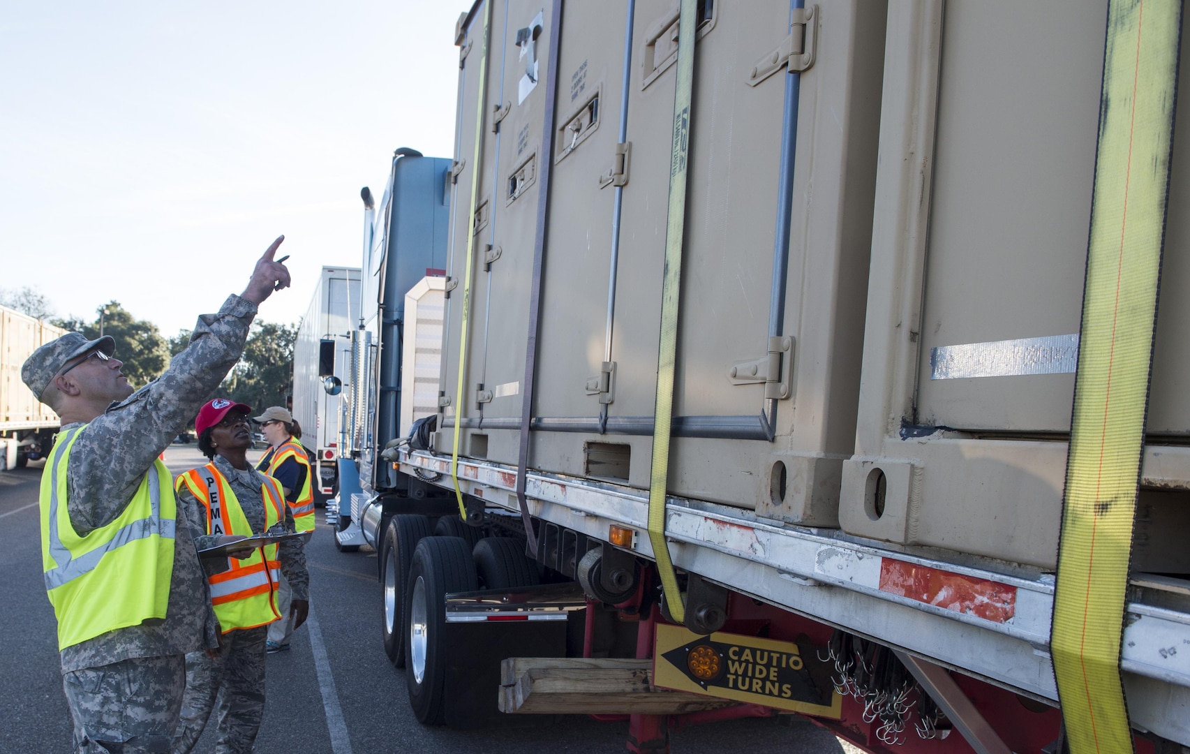 U.S. Army Spc. Derek J. Karbowski, with the 640th Transportation Detachment Tampa, Fla., inspects equipment as it arrives at an initial staging area here Oct. 21 as part of sustained efforts aiding the rebuilding of Puerto Rico in the wake of Hurricane Maria.