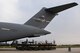 A cargo transport moves in to pusition under the tail of a C-17A from the 445th Airlift Wing, Wright-Patterson Air Force Base, Ohio, Air Force Reserve Command, to load Patriot missiles on to the aircraft at Tinker Air Force Base, Oklahoma, Sept. 12, 2017