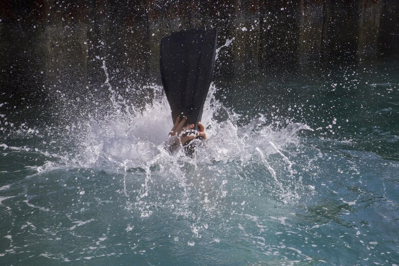 A Recon Team Leaders Course (RTLC) student rehearses a helocasting jump off of the Waterfront Operations pier, Marine Corps Base Hawaii, Oct. 19, 2017. RTLC is an 8-week advanced joint-service course that takes place in three key geographical regions of operation such as classes at Camp Pendleton, California, desert patrol operations in Yuma, Arizona, and ending with jungle and amphibious exercises across Oahu, Hawaii. (U.S. Marine Corps photo by Lance Cpl. Luke Kuennen)