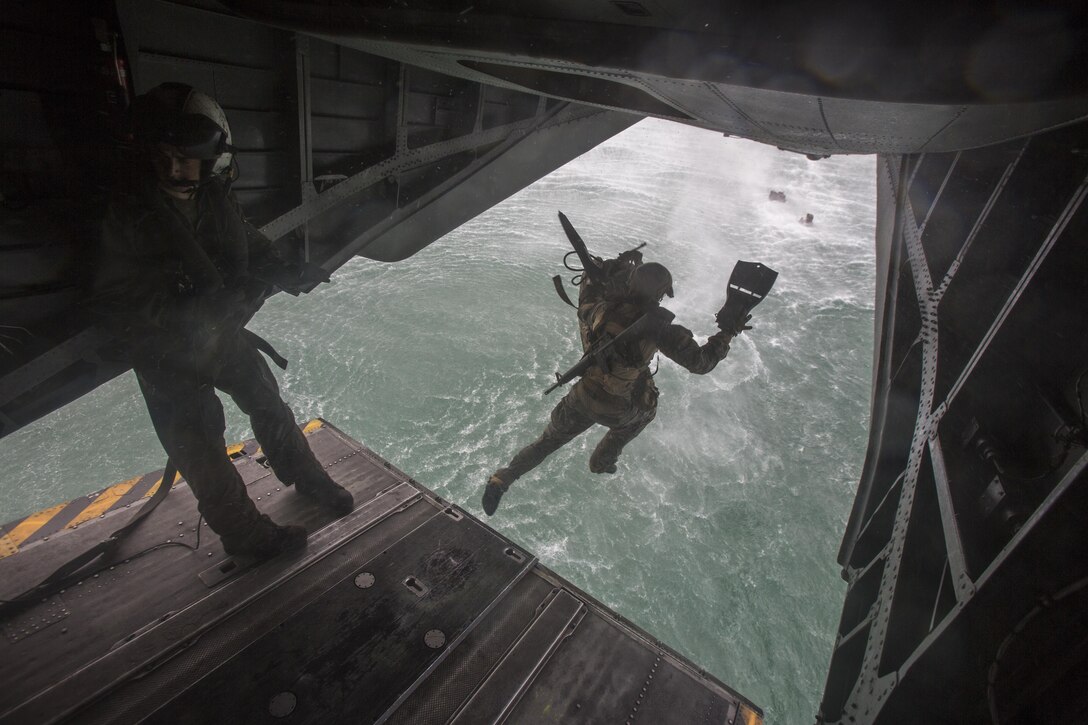 A student of Recon Team Leaders Course (RTLC) jumps out of the back of a CH-53 Super Stallion helicopter during a helocasting exercise, Marine Corps Base Hawaii, Oct. 19, 2017. RTLC is an 8-week advanced joint-service course that takes place in three key geographical regions of operation such as classes at Camp Pendleton, California, desert patrol operations in Yuma, Arizona, and ending with jungle and amphibious exercises across Oahu, Hawaii. (U.S. Marine Corps photo by Lance Cpl. Luke Kuennen)