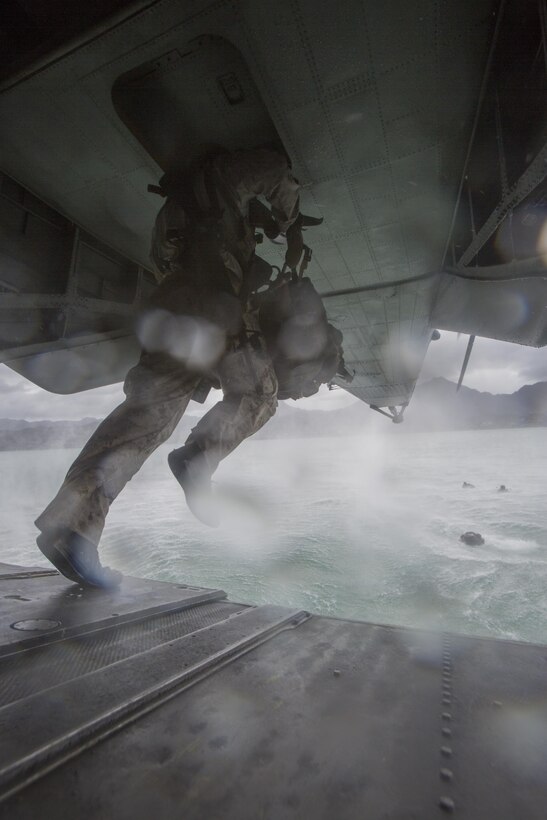 A student of Recon Team Leaders Course (RTLC) jumps out of the back of a CH-53 Super Stallion helicopter during a helocasting exercise, Marine Corps Base Hawaii, Oct. 19, 2017. RTLC is an 8-week advanced joint-service course that takes place in three key geographical regions of operation such as classes at Camp Pendleton, California, desert patrol operations in Yuma, Arizona, and ending with jungle and amphibious exercises across Oahu, Hawaii. (U.S. Marine Corps photo by Lance Cpl. Luke Kuennen)
