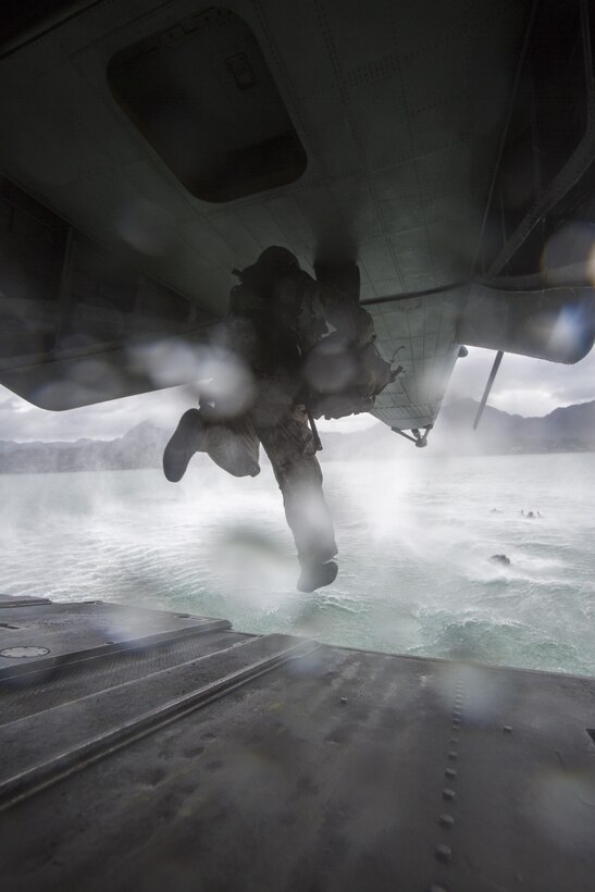 A student of Recon Team Leaders Course (RTLC) jumps out of the back of a CH-53 Super Stallion helicopter during a helocasting exercise, Marine Corps Base Hawaii, Oct. 19, 2017. RTLC is an 8-week advanced joint-service course that takes place in three key geographical regions of operation such as classes at Camp Pendleton, California, desert patrol operations in Yuma, Arizona, and ending with jungle and amphibious exercises across Oahu, Hawaii. (U.S. Marine Corps photo by Lance Cpl. Luke Kuennen)