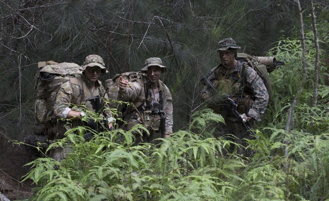 Members of Recon Team Leaders Course (RTLC) discuss their route during a jungle patrol, East Range, Schofield Barracks, Oct. 18, 2017. RTLC is an 8-week advanced joint-service course that takes place in three key geographical regions of operation such as classes at Camp Pendleton, California, desert patrol operations in Yuma, Arizona, and ending with jungle and amphibious exercises across Oahu, Hawaii. (U.S. Marine Corps photo by Lance Cpl. Luke Kuennen)