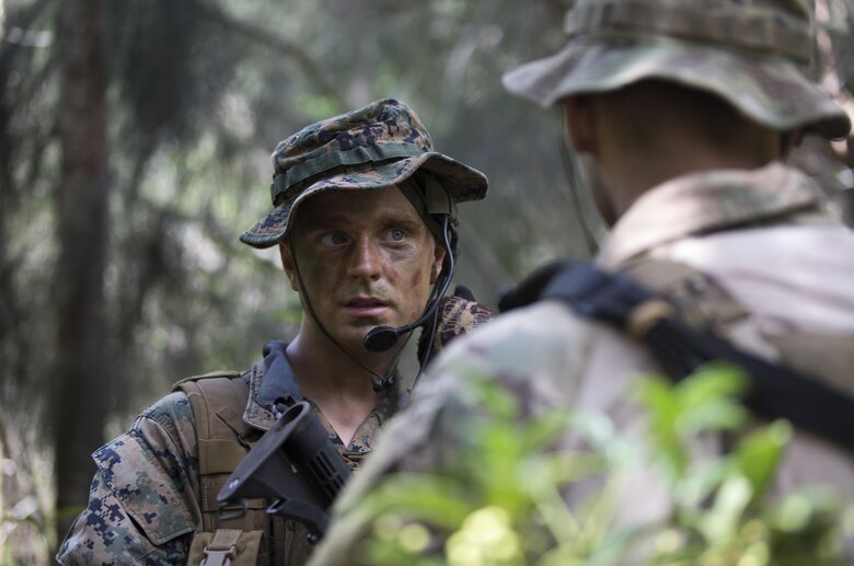 Cpl. Jonathan Schmalhausen, a student of Recon Team Leaders Course (RTLC) communicates with a U.S. Air Force Special Tactics officer while conducting a jungle patrol, East Range, Schofield Barracks, Oct. 18, 2017. RTLC is an 8-week advanced joint-service course that takes place in three key geographical regions of operation such as classes at Camp Pendleton, California, desert patrol operations in Yuma, Arizona, and ending with jungle and amphibious exercises across Oahu, Hawaii. (U.S. Marine Corps photo by Lance Cpl. Luke Kuennen)