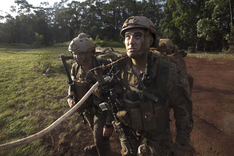Cpl. Samuel Kulenek, a student of Recon Team Leaders Course (RTLC), prepares to be extracted by a CH-53 Super Stallion during a spy-lining exercise, East Range, Schofield Barracks, Oct. 19, 2017. RTLC is an 8-week advanced joint-service course that takes place in three key geographical regions of operation such as classes at Camp Pendleton, California, desert patrol operations in Yuma, Arizona, and ending with jungle and amphibious exercises across Oahu, Hawaii. (U.S. Marine Corps photo by Lance Cpl. Luke Kuennen)
