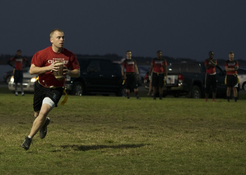 A 30th Intelligence Squadron flag football team member runs with a football during the 2017 Intramural Flag Football Championship Game at Joint Base Langley Eustis, Va., Oct. 20, 2017.