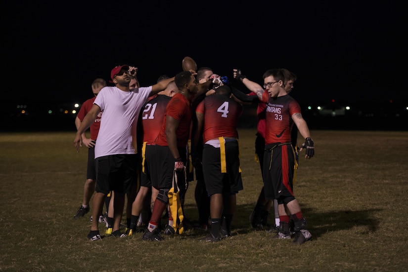 The 30th Intelligence Squadron flag football team gather for a team chant as they prepare for the 2017 Intramural Flag Football Championship Game at Joint Base Langley Eustis, Va., Oct. 20, 2017.