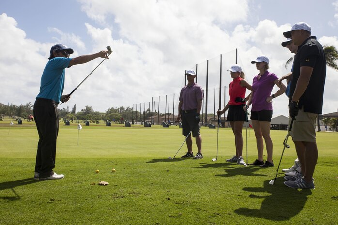 John Radke, an instructor with the Salute Military Golf Association (SMGA) demonstrates a proper golf technique during the Warriors Golf Clinic at the Kaneohe Klipper’s Golf Course, Marine Corps Base Hawaii, Oct. 21, 2017. The SMGA is a non-profit organization that serves Post 9/11 wounded veterans by introducing the sport of golf as a diversion for rehabilitation through Warrior Golf Clinics. (U.S. Marine Corps photo by Cpl. Jesus Sepulveda Torres)