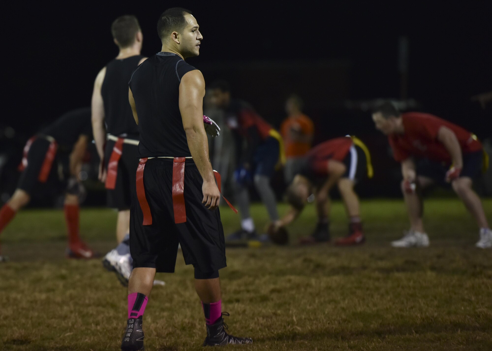 A 633rd Medical Group flag football team member walks on the field during the 2017 Intramural Flag Football Championship Game at Joint Base Langley Eustis, Va., Oct. 20, 2017.