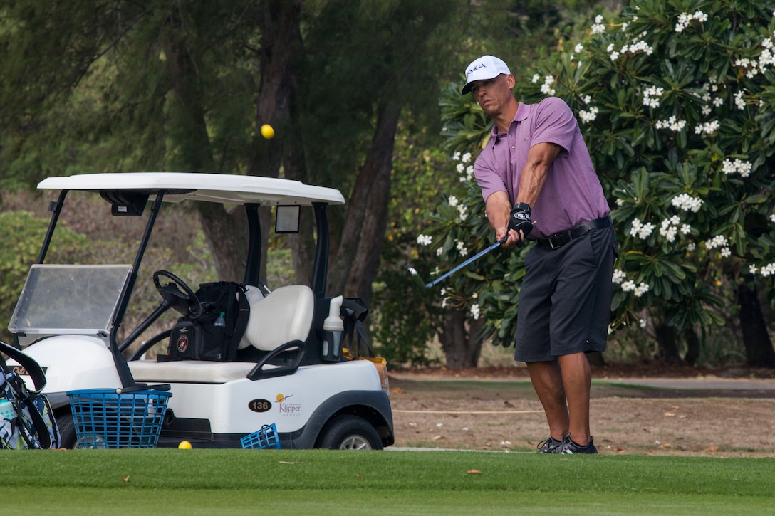 John Radke, an instructor with the Salute Military Golf Association (SMGA) demonstrates a proper golf technique during the Warriors Golf Clinic at the Kaneohe Klipper’s Golf Course, Marine Corps Base Hawaii, Oct. 21, 2017. The SMGA is a non-profit organization that serves Post 9/11 wounded veterans by introducing the sport of golf as a diversion for rehabilitation through Warrior Golf Clinics. (U.S. Marine Corps photo by Cpl. Jesus Sepulveda Torres)