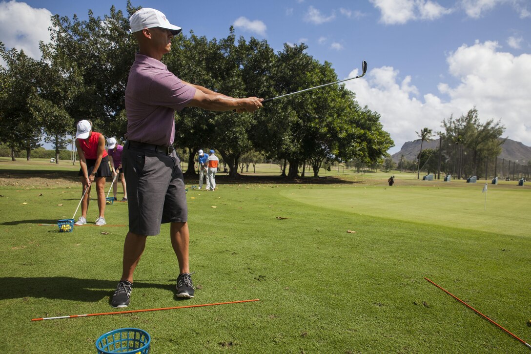 U.S. Army 1st Lt. Ryan White, the current operations officer with the 130th Engineer Brigade, practices his golf swing during a Warriors Golf Clinic held by the Salute Military Golf Association (SMGA) at the Kaneohe Klipper’s Golf Course, Marine Corps Base Hawaii, Oct. 21, 2017. The SMGA is a non-profit organization that serves Post 9/11 wounded veterans by introducing the sport of golf as a diversion for rehabilitation through Warrior Golf Clinics. (U.S. Marine Corps photo by Cpl. Jesus Sepulveda Torres)