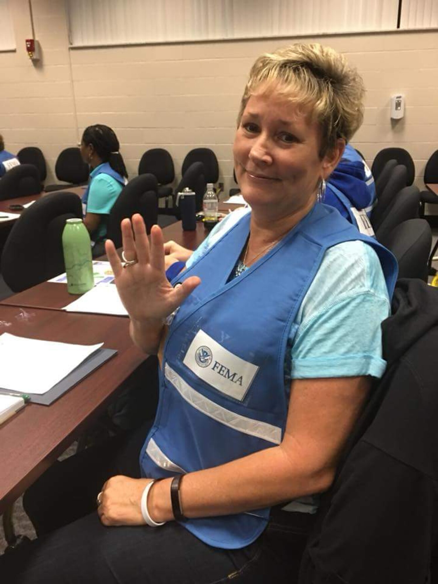 Lorie Bellamy, 436th Airlift Wing occupational safety manager, poses for a photo at a Federal Emergency Management Agency hurricane relief call center in Denton, Texas. Bellamy is one of 70 Air Force civilian volunteers currently assigned to the Department of Homeland Security’s Surge Capacity Force providing aid to Americans affected by Hurricanes Harvey, Irma and Maria. (Courtesy Photo)