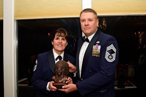 Chief Master Sgt. Dale Gunter presents a sculpture to Chief Master Sgt. Lynn U. Oatman during the Montana Air National Guard Chief Induction Ceremony held at the Meadowlark Country Club in Great Falls, Mont., Oct. 14, 2017. Chief Master Sgts. Chad W. Anderson, Joel R. Clum, Lynn U. Oatman and Sean P. O'Connell were inducted during the ceremony into the top United States Air Force enlisted rank. (U.S. Air National Guard photo/Senior Master Sgt. Eric Peterson)