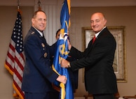 Air Force Sustainment Center Commander Lt. Gen. Lee K. Levy II exchanges the flag with Dennis D’Angelo, the new director for the 448th Supply Chain Management Wing, in a formal Change of Leadership ceremony Oct. 17 at the Tinker Club.