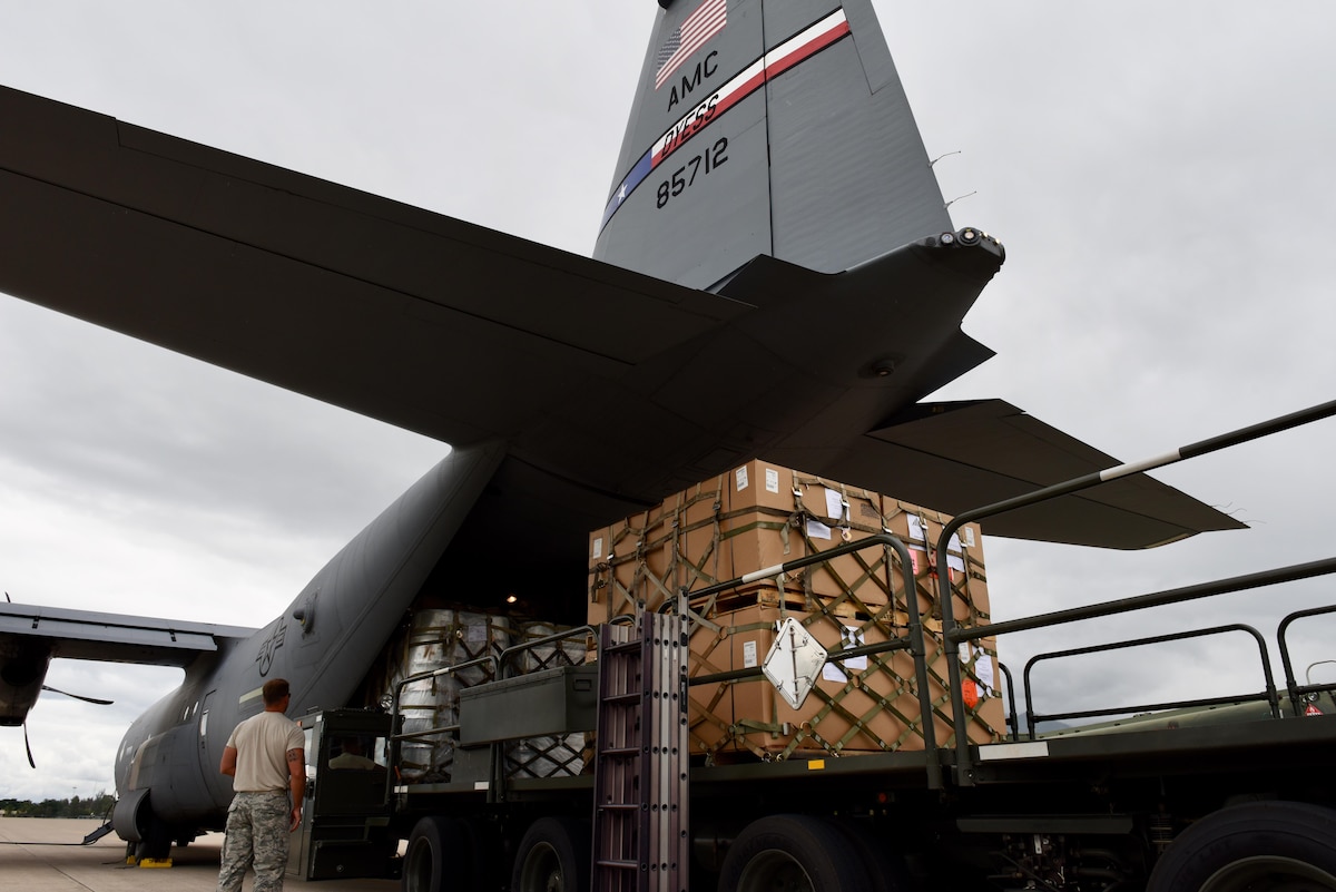 A 317th Airlift Wing crew works with air transporters from the 612th Air Base Squadron to off load pallets during a routine global channel mission Oct. 18, 2017, to Soto Cano Air Base, Honduras. The C-130J crew delivered sustainment and supplies to Airmen supporting Joint Task Force-Bravo.  Airmen from Soto Cano Air Base rely on the mission to bring items needed to complete their mission while stationed in the Central American country.  (Air Force photo by Master Sgt. Kristine Dreyer)