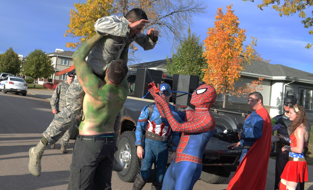 Jon Spiecher, the resource advisor for the 28th Security Forces Squadron, dressed as a superhero, stops a “criminal” played by Airman 1st Class Michael Escalante, a 28th SFS member, at Ellsworth Air Force Base, S.D., Oct. 11, 2017.  The SFS hosts the annual Superhero Parade for Crime Prevention Month among others including Trunk or Treat, Little Defenders, Pumpkin Patrol, Cops and Neighbors, a weapons display and a visit to the Child Development Center by McGruff the Crime Dog. (U.S. Air Force photo by Airman 1st Class Thomas Karol)