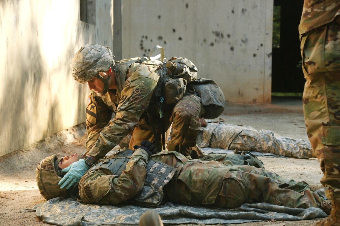 A soldier performs tactical field medical care during the Expert Field Medical Badge testing.