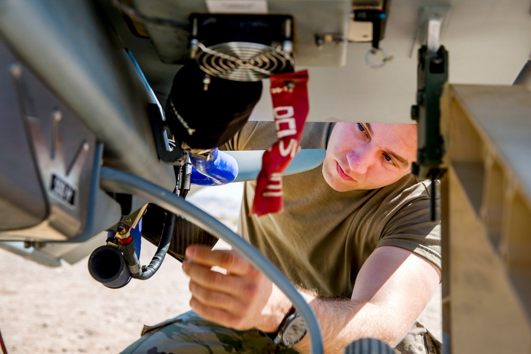 Army Staff Sgt. Andrew McMillan inspects an RQ-7B Shadow before launch during Integrated Training Exercise 1-18.