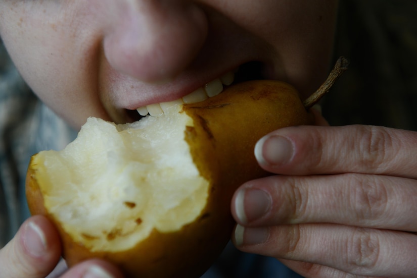 An Airman eats a Bosc pear, which is high in fiber and vitamin C, at Joint Base Elmendorf-Richardson, Alaska, Oct. 17, 2017. Fruits and vegetables are packed with vitamins and minerals, also known as micronutrients, which are vital for the human body’s many functions such as digestion, metabolism, and healing.