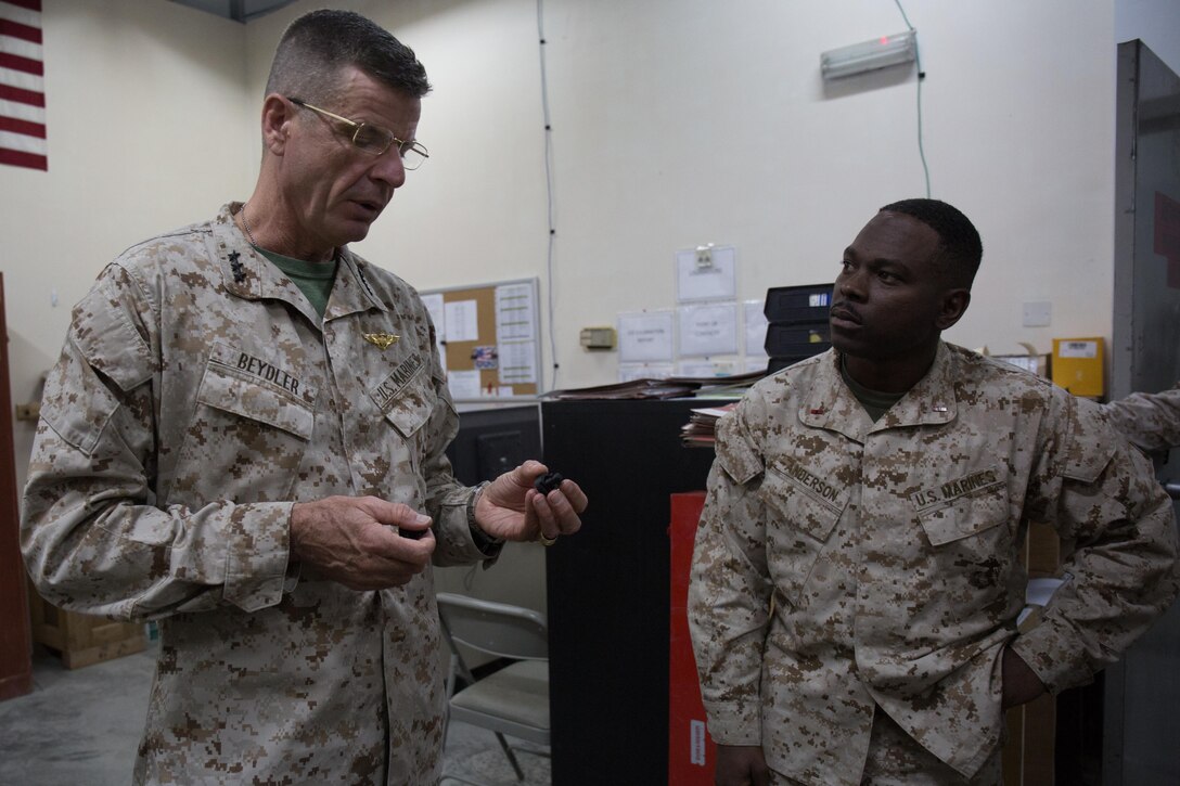 U.S Marine Lt. Gen. William D. Beydler, commander, U.S. Marine Corps Forces Central Command, inspects a 3D printed component while being briefed by Chief Warrant Officer 3 Dave R. Anderson, the maintenance management officer with Combat Logistics Detachment  5, on how 3D printing enhances the capabilities of the logistics combat element of Special Purpose Marine Air-Ground Task Force – Crisis Response – Central Command 17.2 while in the Middle East Oct. 24, 2017. Beydler visited the Marines to listen to their questions, share his guidance and discuss their daily operations.