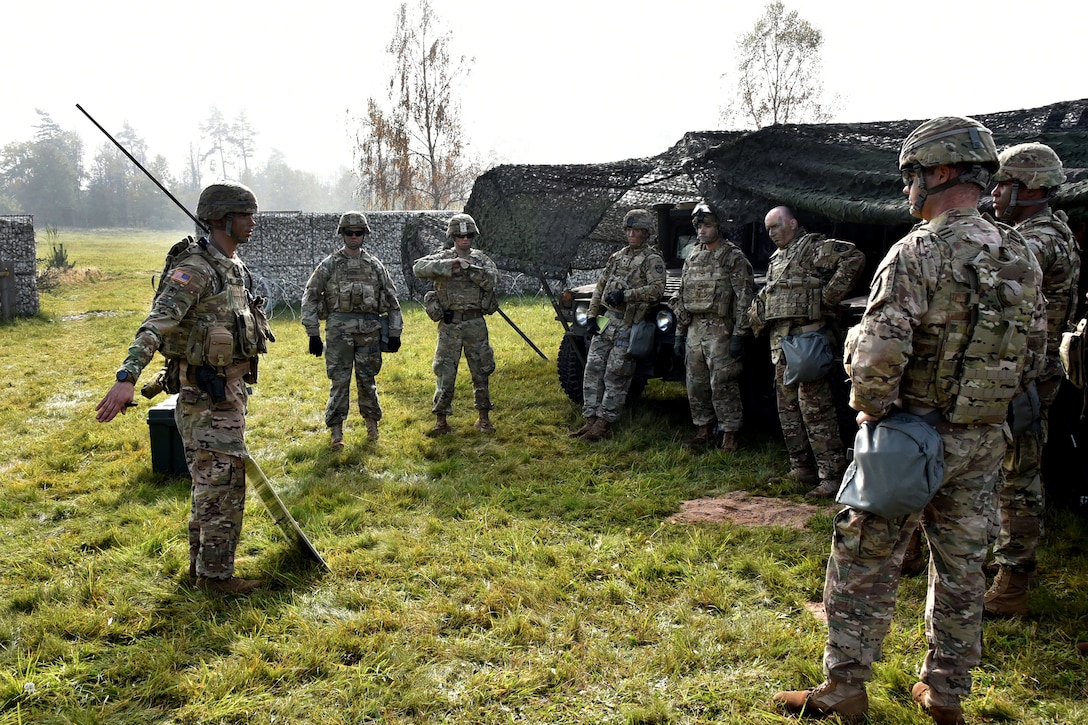 Staff Sgt. Phillip Smith, left, gives a mission brief to soldiers before participating in urban operations training.