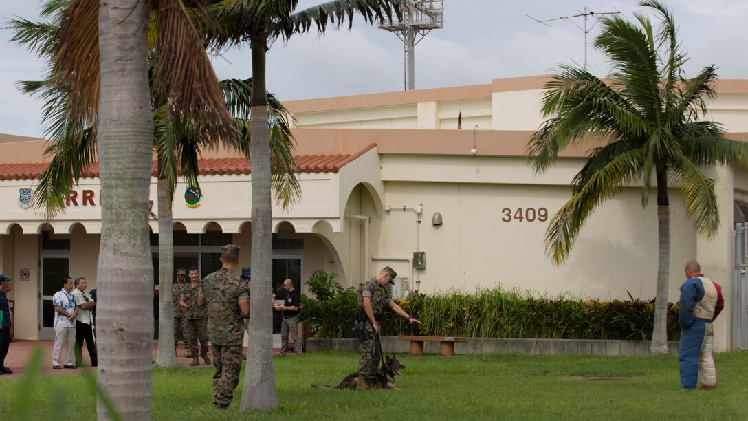 Lance Cpl. Garrett Impola shows control of his dog during a K-9 aggression demonstration.