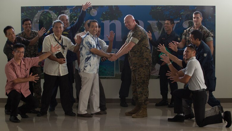 Okinawa Prefectural Police officers and Marine Corps Installations Pacific Provost Marshall Office’s K-9 poses for a photo after a K-9 demonstration.