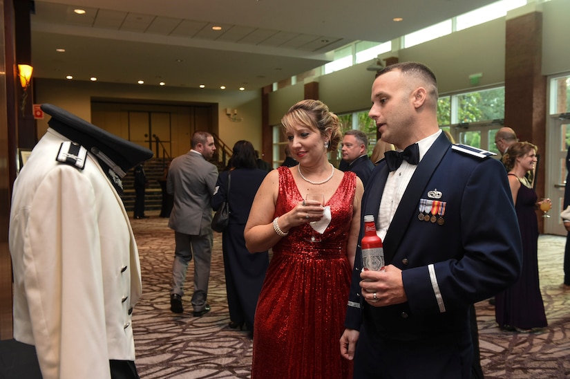 1st Lt. Christopher Long, 315th Maintenance Squadron maintenance flight commander, explains to his wife, Amanda, the history of the Air Force’s Summer White Mess Dress uniform during the Air Force Ball at the Charleston Area Convention Center in North Charleston, S.C., Oct. 21, 2017.