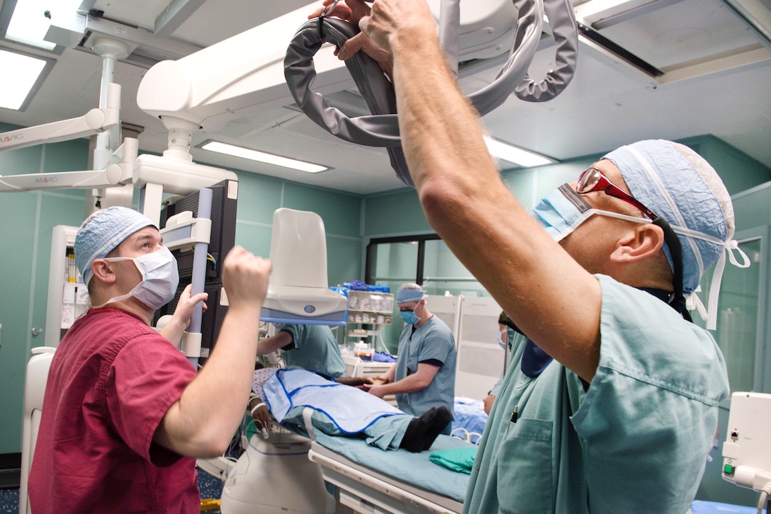 Sailors prepare for a surgical operation in an operating room aboard the hospital ship USNS Comfort