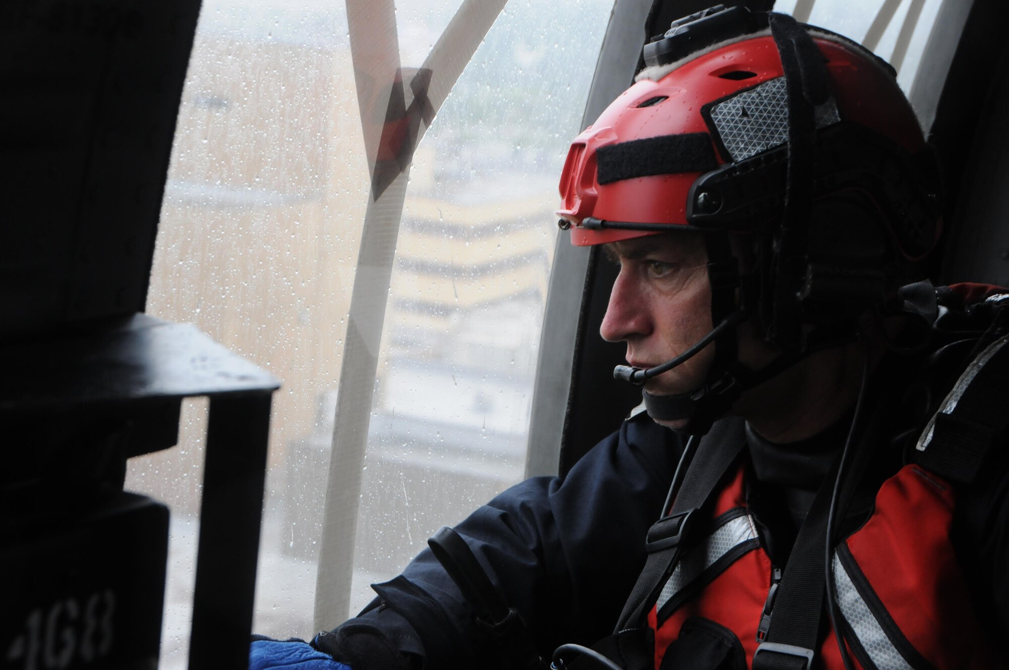 Maj. Glynn Weir, a combat rescue officer, assigned to the New York Air National Guard's 106th Rescue wing surveys the flood waters engulfing Houston, Texas during rescue operations on August, 30, 2017. The New York Air National Guard dispatched 120 Airmen, 3 HH-60 Pavehawk rescue helicopters and two HC-130 search and rescue aircraft to aid the Texas National Guard. (U.S. Air National Guard photo by A1C Daniel Farrell)