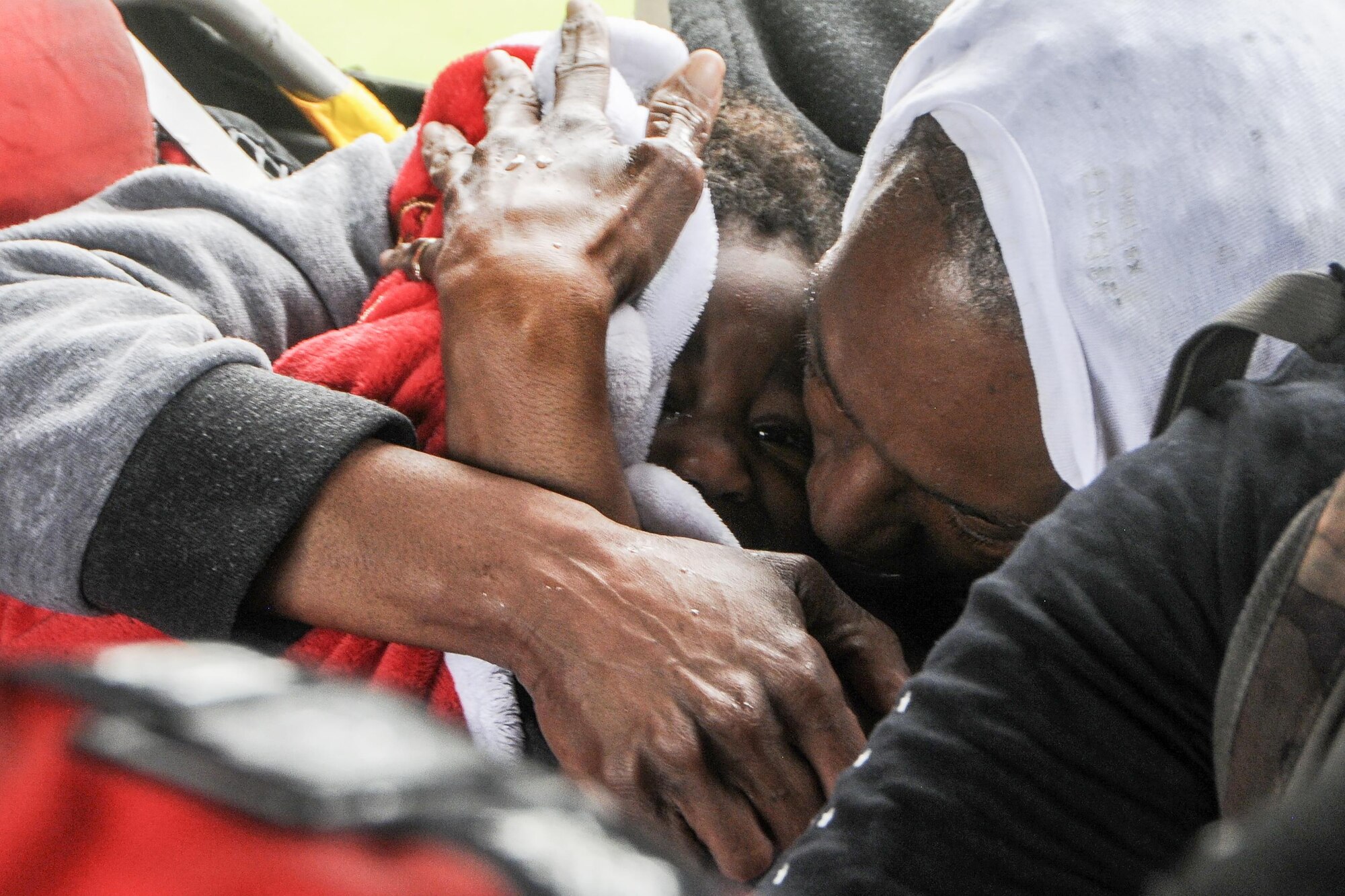 A woman comforts a child in the cabin of the HH-60 Pave Hawk helicopter, operated by Airmen of the 106th Rescue Wing assigned to the New York Air National Guard, over Beaumont, August 30, 2017. The members of the 106th pulled the family up from flood waters in front of their home and dropped them off safely at a casualty collection point as the 106th Rescue Wing Search and Rescue mission continued in support of Texas after Hurricane Harvey . (U.S. Air National Guard photo by Daniel H. Farrell)