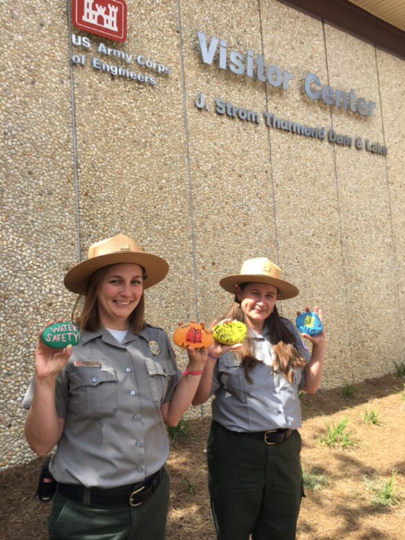 Park Rangers Heather Killips and Sheila Larson share rocks painted by volunteers as part of Thurmond Lake's National Public Lands Day event, Sept. 30.  The rocks are being placed around Thurmond’s public areas for visitors to find and share on social media.