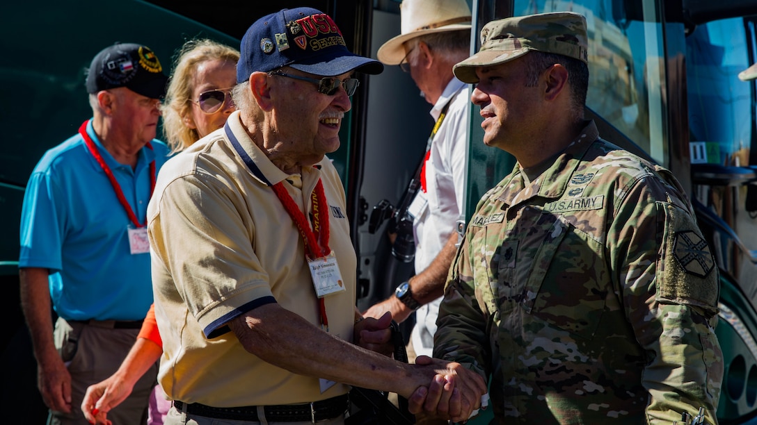 U.S. Marine veteran Ralph Simoneau from the 5th Marine Division shakes hands with Garrison Commander, Lt. Col. Cristopher Marquez.