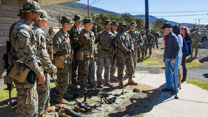 U.S. Marine veteran Carl DeHaven of the 5th Marine Division, talks with Marines from 2nd Battalion, 3rd Marine Regiment.