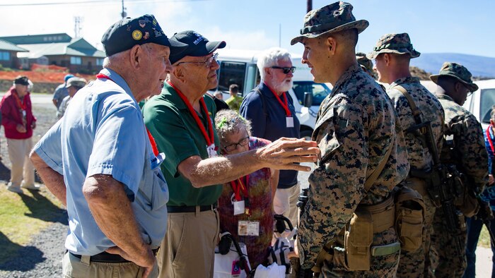 U.S. Marine veterans from the 5th Marine Division talk with U.S. Marine Sgt. Tyler Zeller, a member of 2nd Battalion, 3rd Marines.