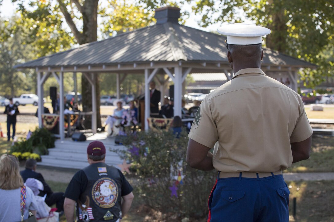 A local Marine recruiter watches Gov. Phil Bryant, the governor of Mississippi, give a speech to residents of his hometown, Moorhead, Miss., Oct. 19, 2017. Leaders with 4th Marine Aircraft Wing, Marine Forces Reserve, and a host of residents and other service members attended the event that not only celebrated the 200th birthday of Mississippi, but to also pay tribute to the 15 Marines and one sailor who perished in a C-130 crash in July 2017. (U.S. Marine Corps photo by Cpl. Dallas Johnson)