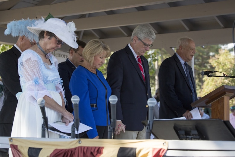 Phil Bryant (center), the governor of Mississippi, and his wife Deborah Bryant, bow their heads in prayer during the invocation, led by Ray Bridges (right), at the Mississippi Bicentennial Celebration, in Moorhead, Miss., Oct. 19, 2017. The Moorhead Garden Club held Mississippi's 200th birthday in Moorhead to not only celebrate the state's birthday, but to also honor, and pay tribute to, the 15 Marines and one sailor who perished in a C-130 plane crash on July 10, 2017, in the nearby county of Leflore. (U.S. Marine Corps photo by Cpl. Dallas Johnson)